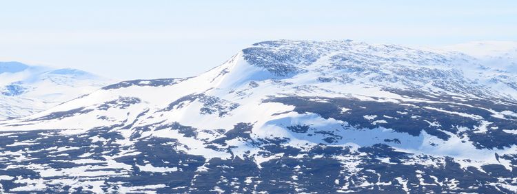 The photo shows a snow-covered mountain.