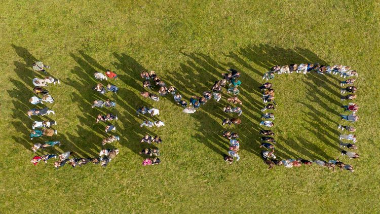 The picture is an aerial view and shows how the students form the lettering "UMO".